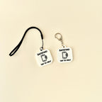 A compact and stylish SafeTag keyring designed for NFC functionality, available in sleek black or white.