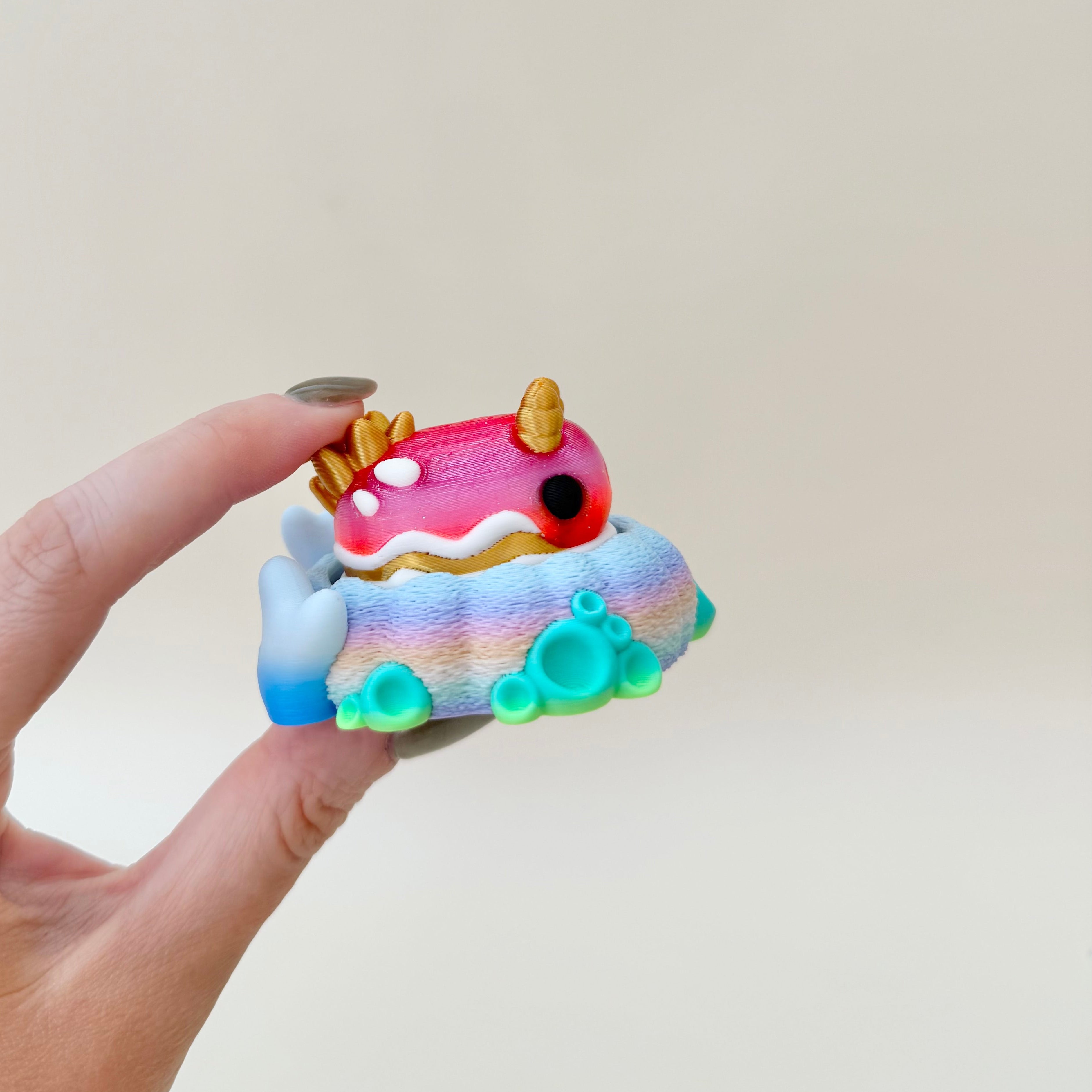 Mini ocean-inspired fidget with smooth detailed finish and colourful coral base for sensory play and display.
