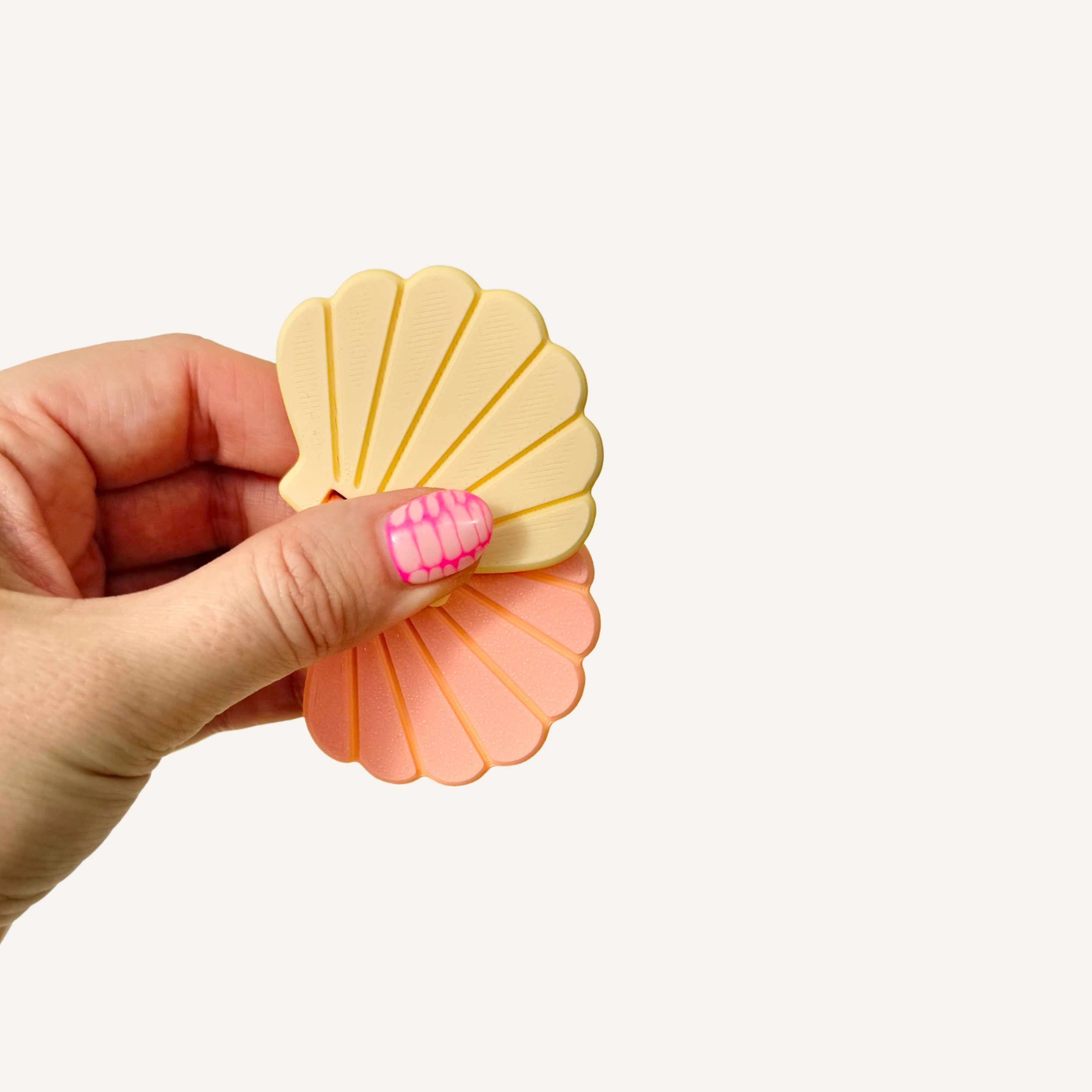 Pastel seashell flip fidget designed for smooth twisting and flipping movement.
