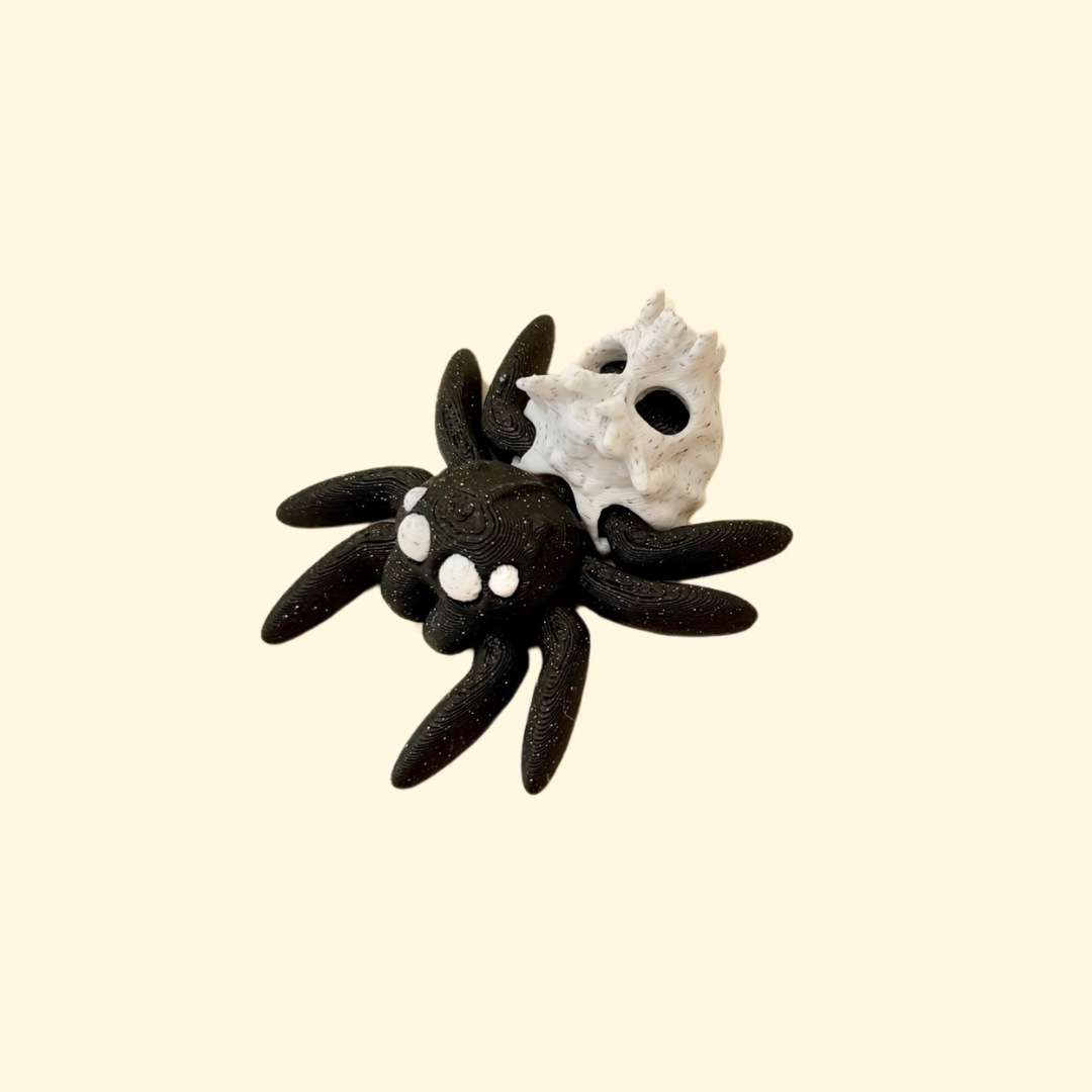 mini articulated spider fidget with sparkly black body and marbled skull detail for sensory play
