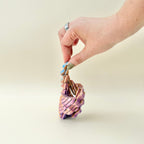 Compact visual fidget that opens into a stretched helix shape with textured movement and a rasping sound.
