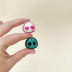 pocket skull clicker with raised details for tactile input
