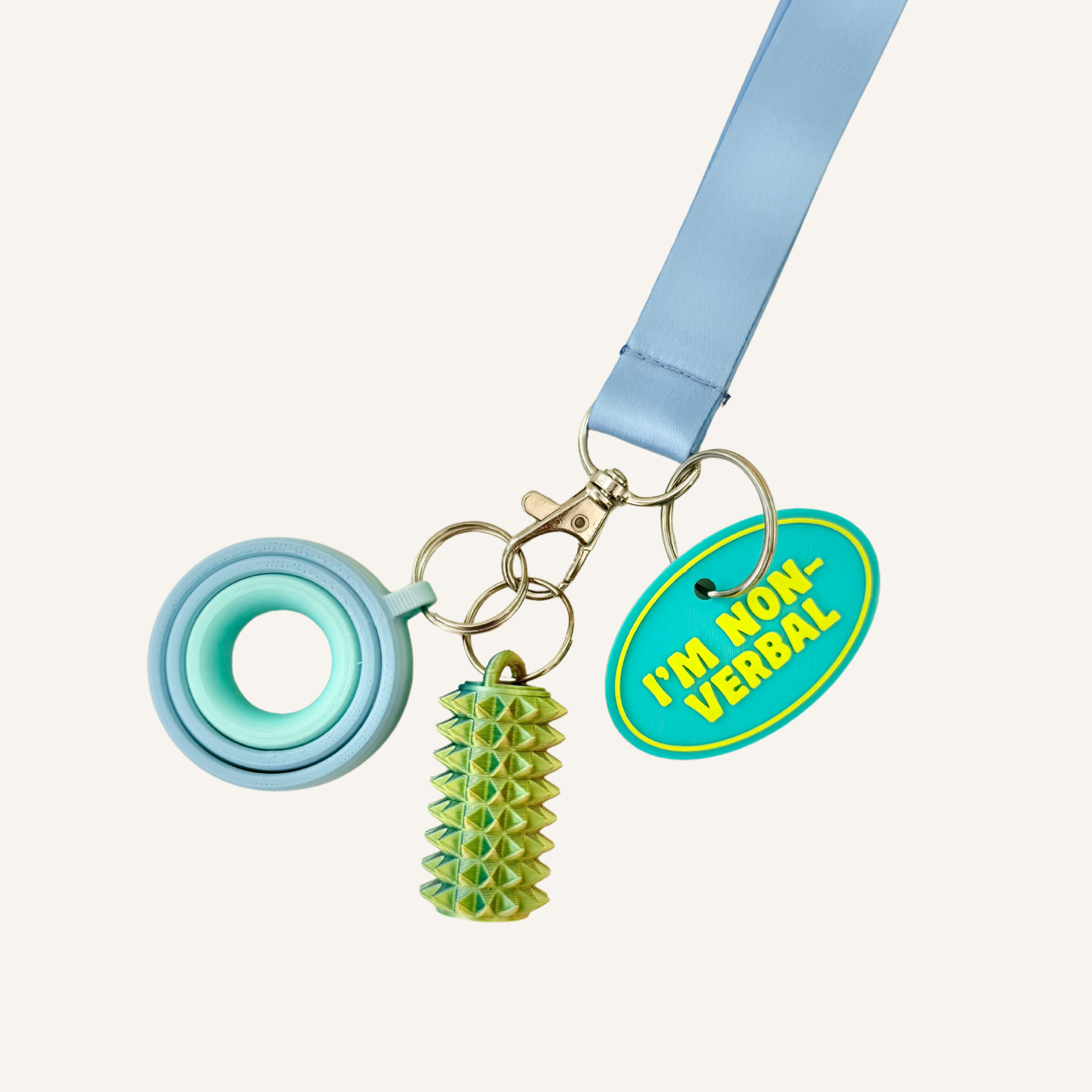 3D printed communication tag with raised text and silver loop for everyday visible support.