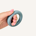 Circular sensory fidget with rotating inner ring and textured outer edge for pressure feedback.