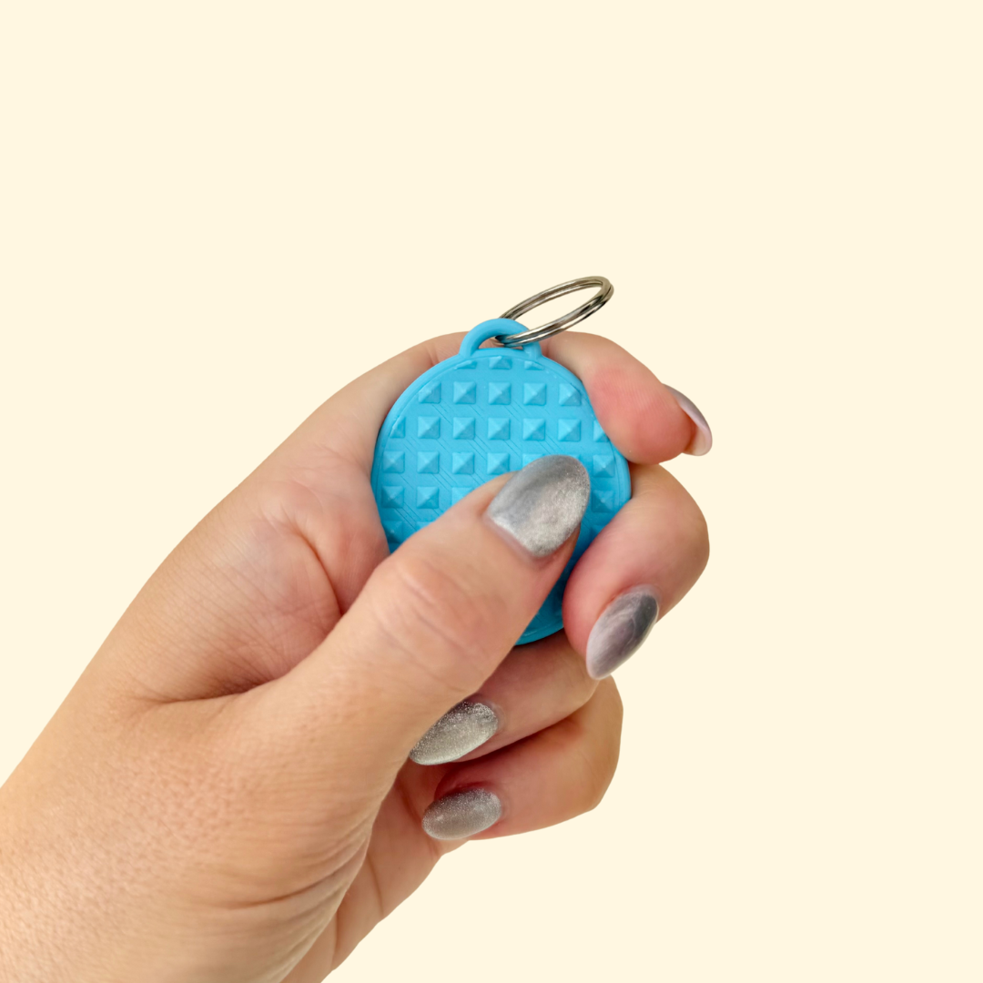 Quiet tactile add-on designed for lanyards and keyrings, offering controlled texture for regulation and focus.
