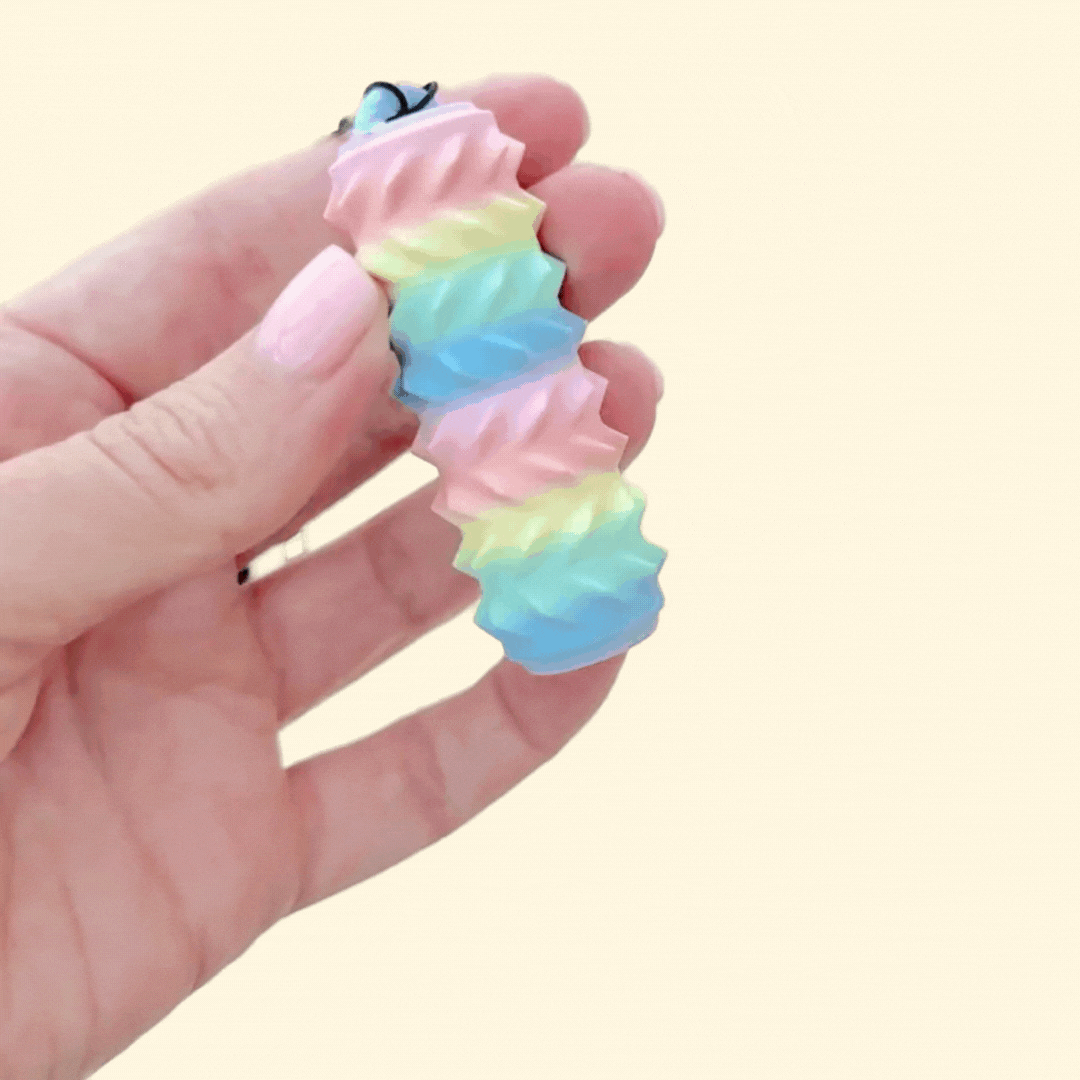 Handheld stim tool with removable strap for on-the-go sensory support.
