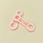 Dual-ended fidget spinner with tactile rings and rotating stim bar for sensory input and fidget use.
