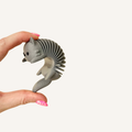 Quiet cat fidget with a flexible spring body and tactile textured finish.