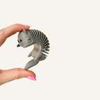 Quiet cat fidget with a flexible spring body and tactile textured finish.