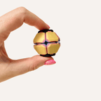 Spring-loaded sensory fidget that pops open with every press for repetitive hand movement.