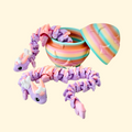 Lilac and peach gradient dragon with articulated body alongside a rainbow star-embossed egg.