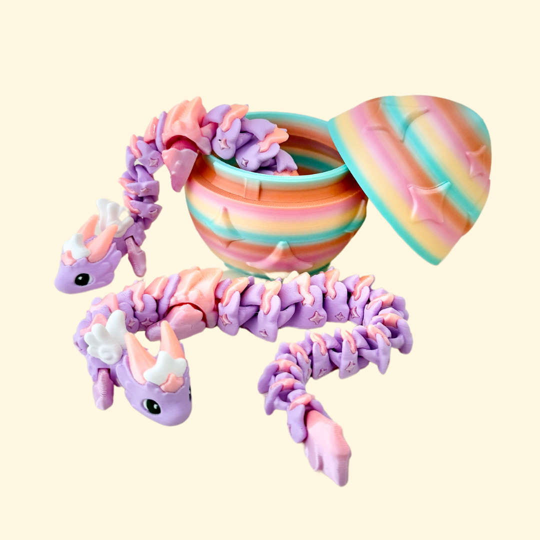 Lilac and peach gradient dragon with articulated body alongside a rainbow star-embossed egg.