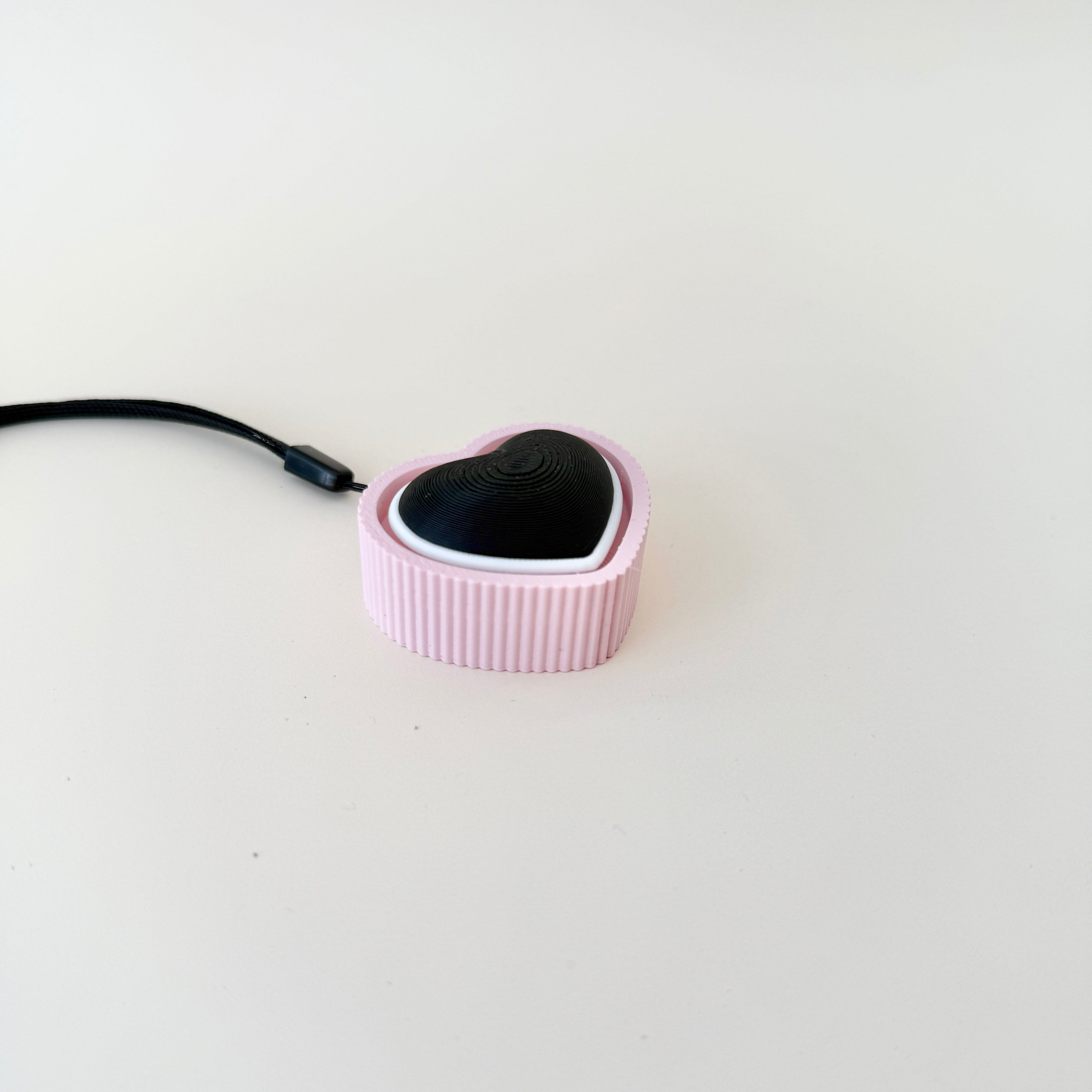 A modern and practical fidget toy with a heart shape and pop-click mechanism.