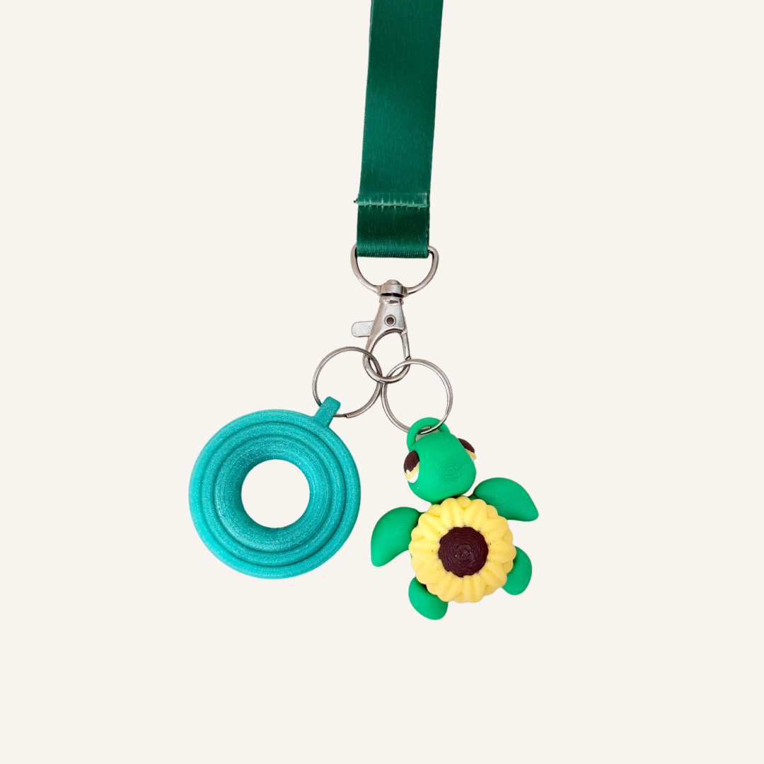 Lanyard-friendly turtle fidget with raised flower detail for tracing, touch and discreet stimming on the go.