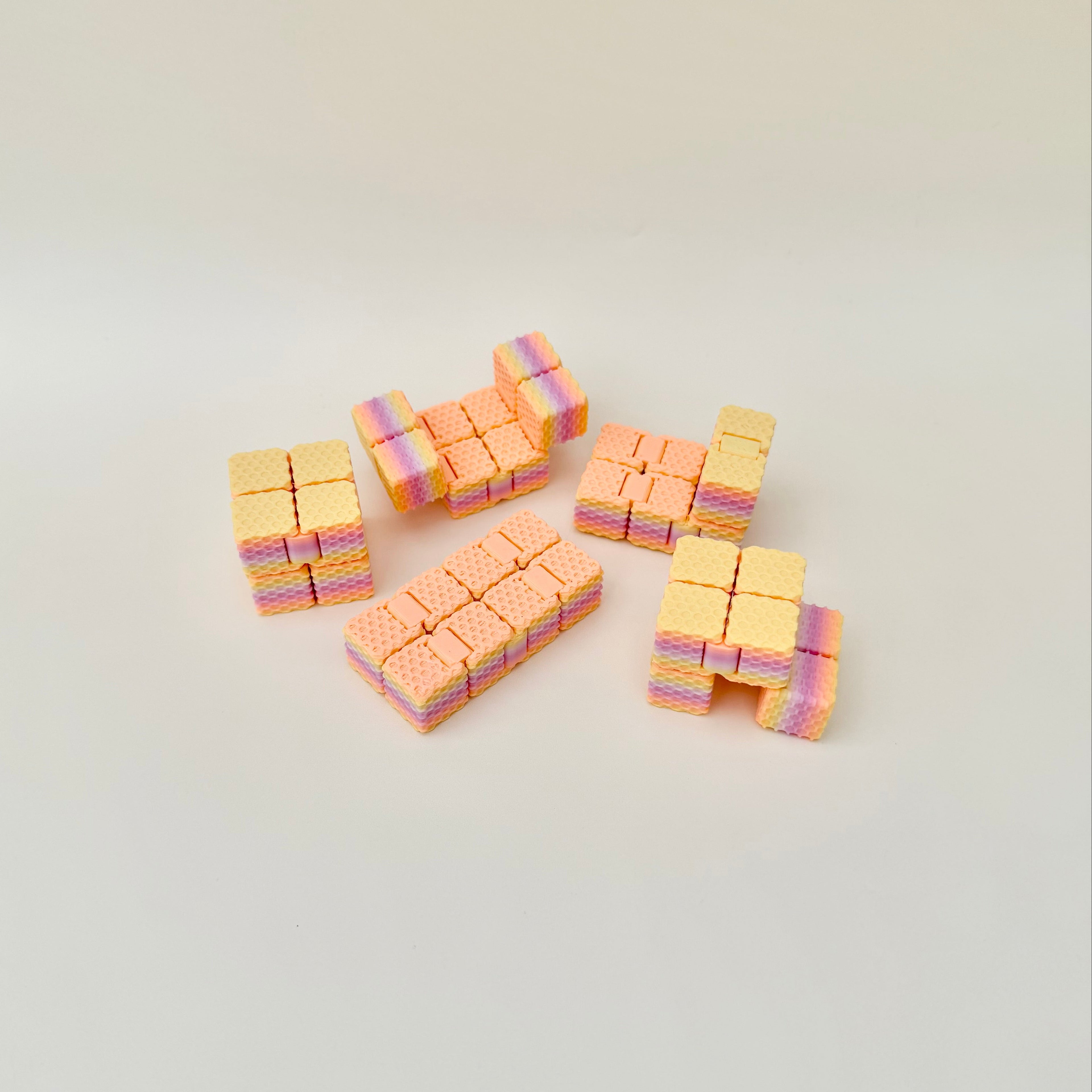 Small textured sensory fidget with clicky folds and smooth movement that loosens with use.
