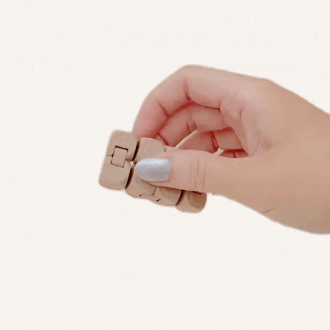 Small sensory cube fidget with raised dot texture and clicky movement for calming hands.
