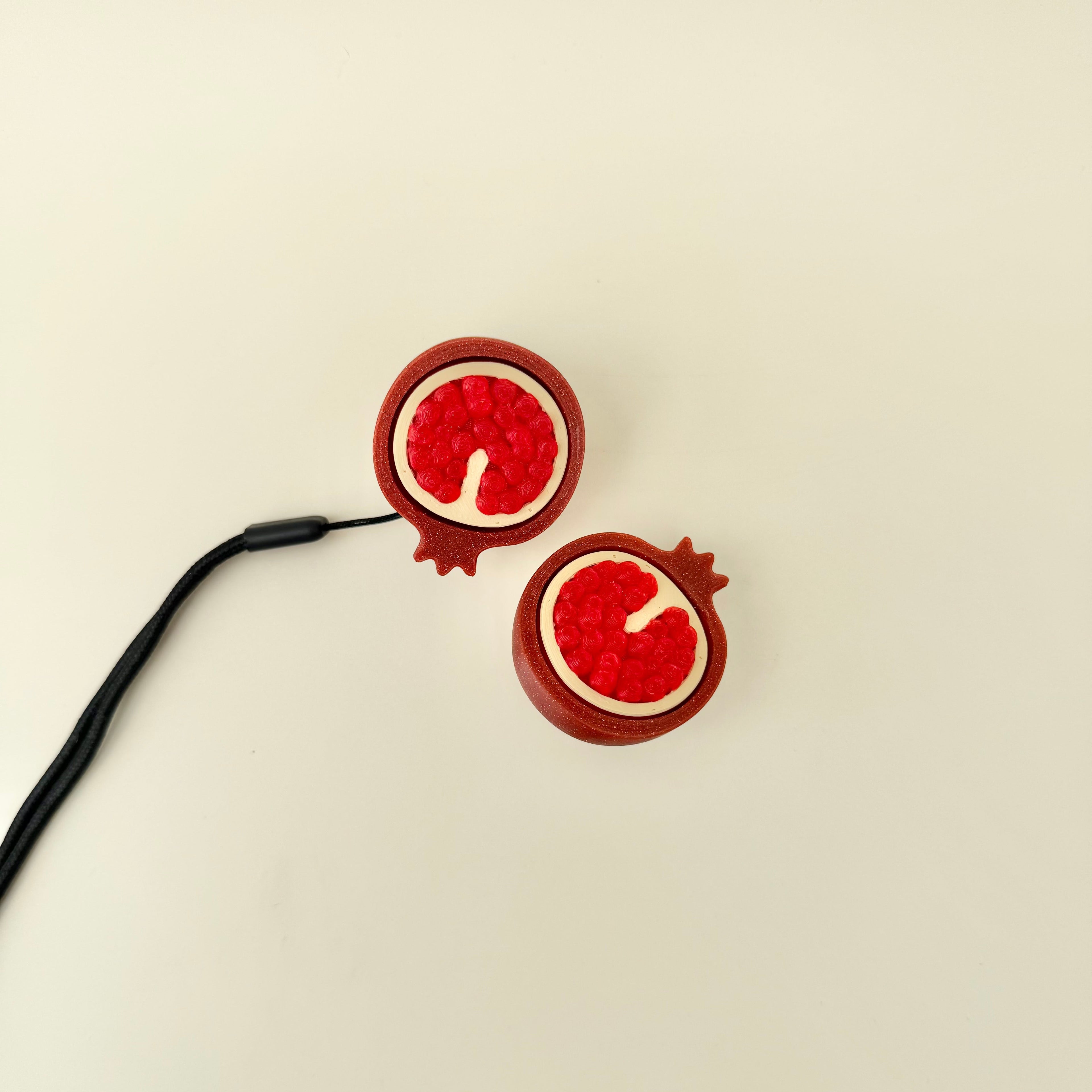 Small fidget with raised detailing for finger tracing and a central press function for repetitive movement