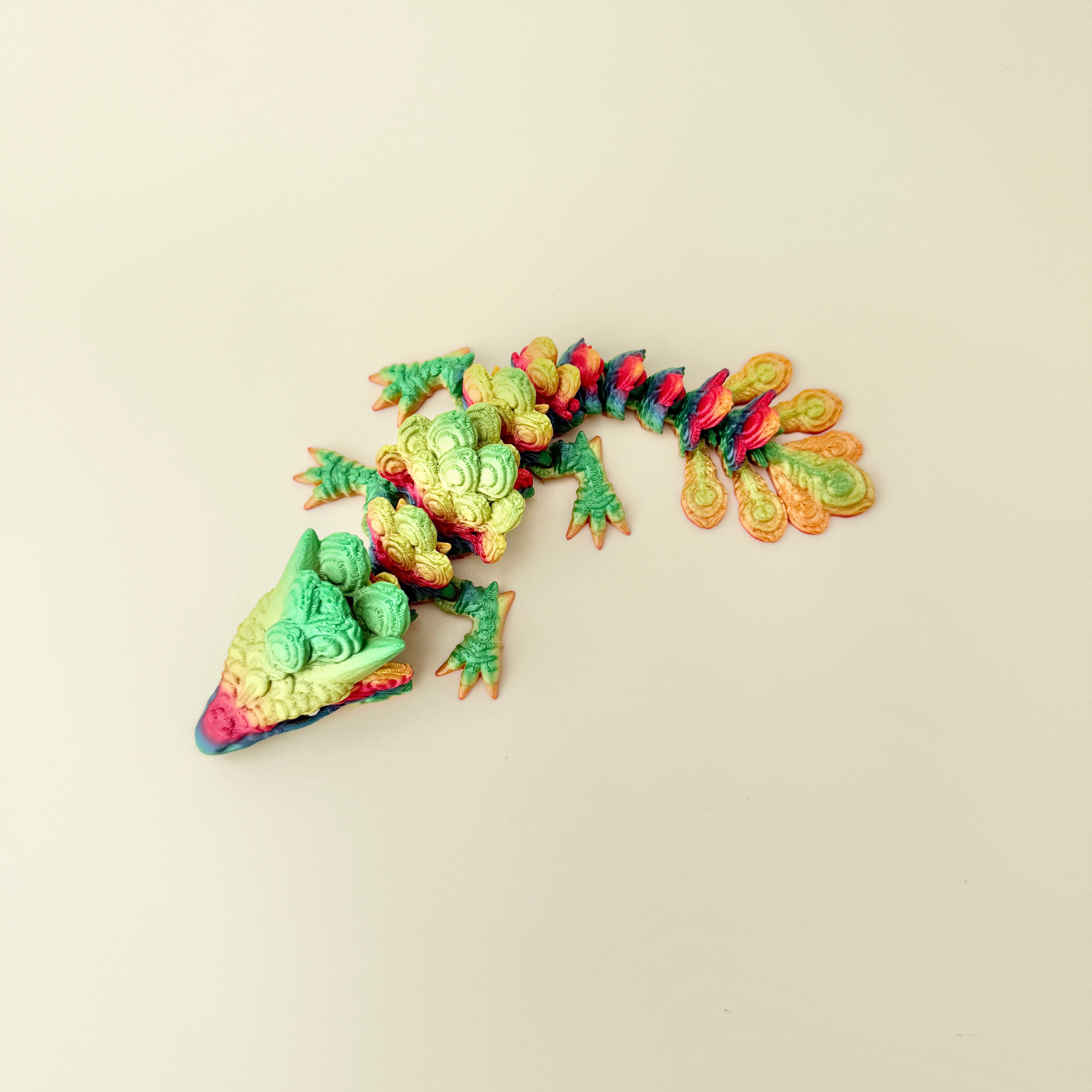 dragon-shaped sensory figure featuring layered feather-like scales and smooth movement for tactile regulation
