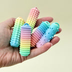 Rigid palm-sized fidget tool with varied textures for sensory support and tactile input.