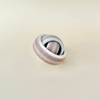Tactile spin fidget with micro-texture edge and smooth inner rings for steady, satisfying hand movement.
