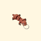 Sensory fidget attachment with fine surface texture for slow tracing and grounding on the go.
