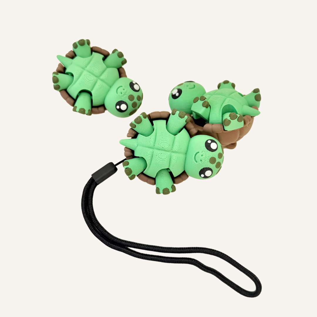 Pressable turtle fidget with tummy click action, leg movement and portable sensory use.
