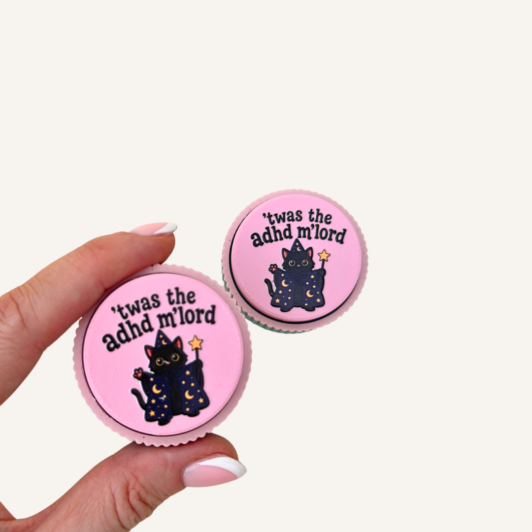 Close-up of the pink textured clicker with colourful wizard cat artwork