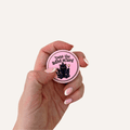 Two pink Twas The ADHD Mlord sensory clickers with wizard cat artwork