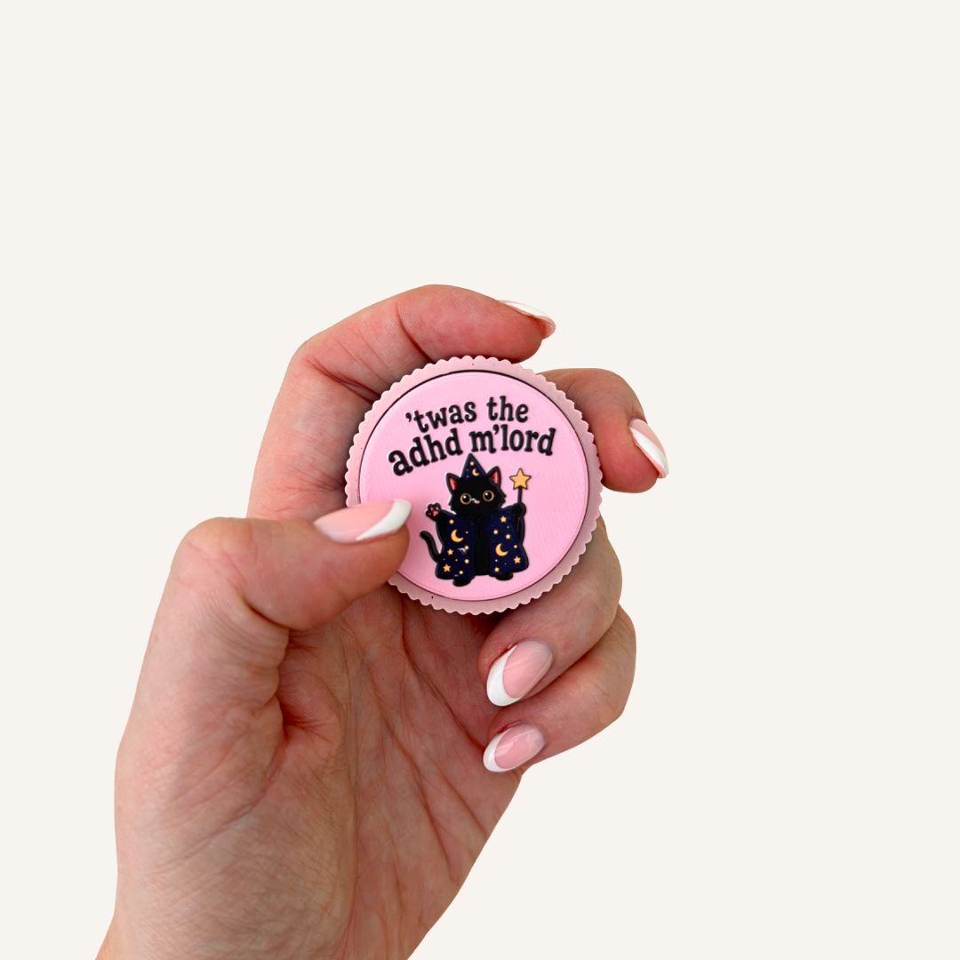 Pink and rainbow sensory clicker with tactile ridged finish and wizard cat design