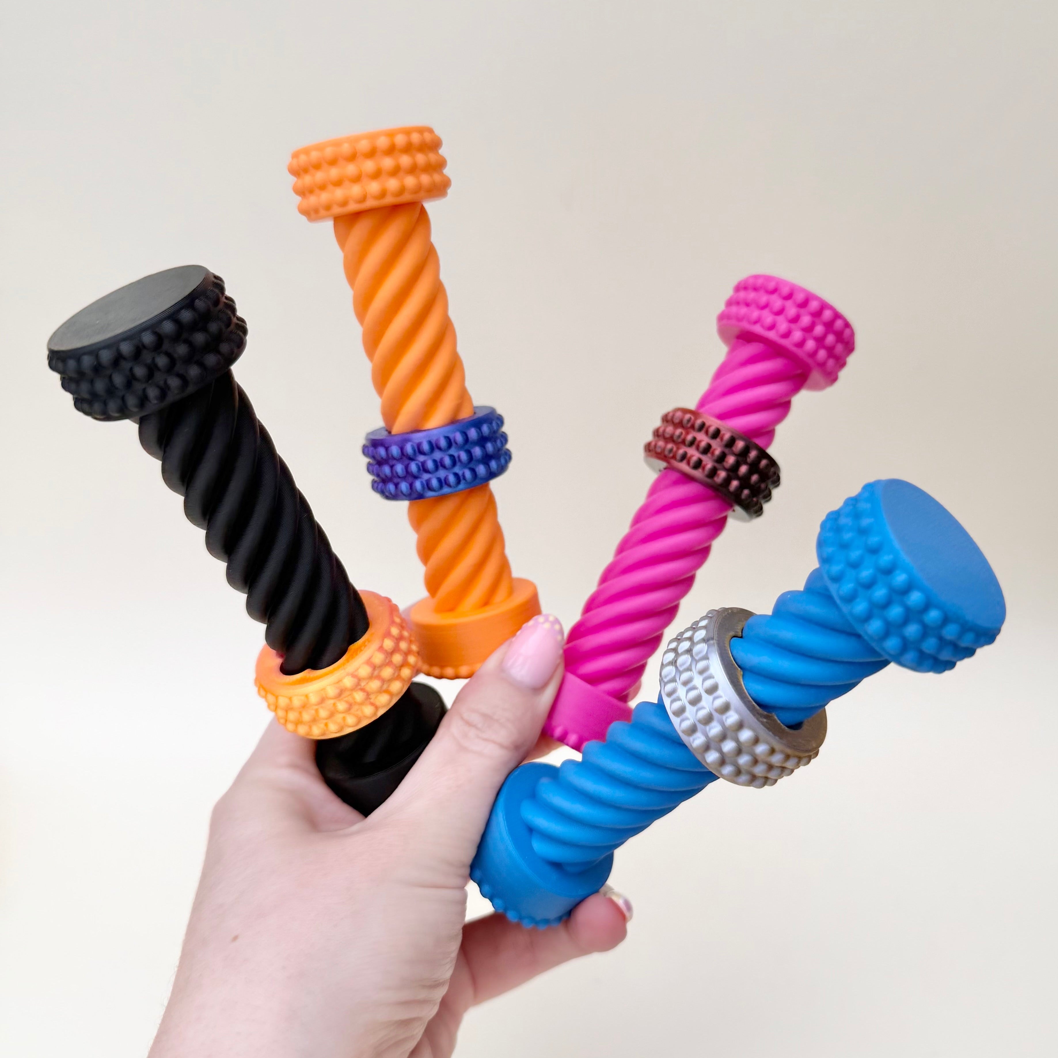 Visual stim fidget with a spiral body and sliding ring designed for repetitive twisting and calming hand movement.
