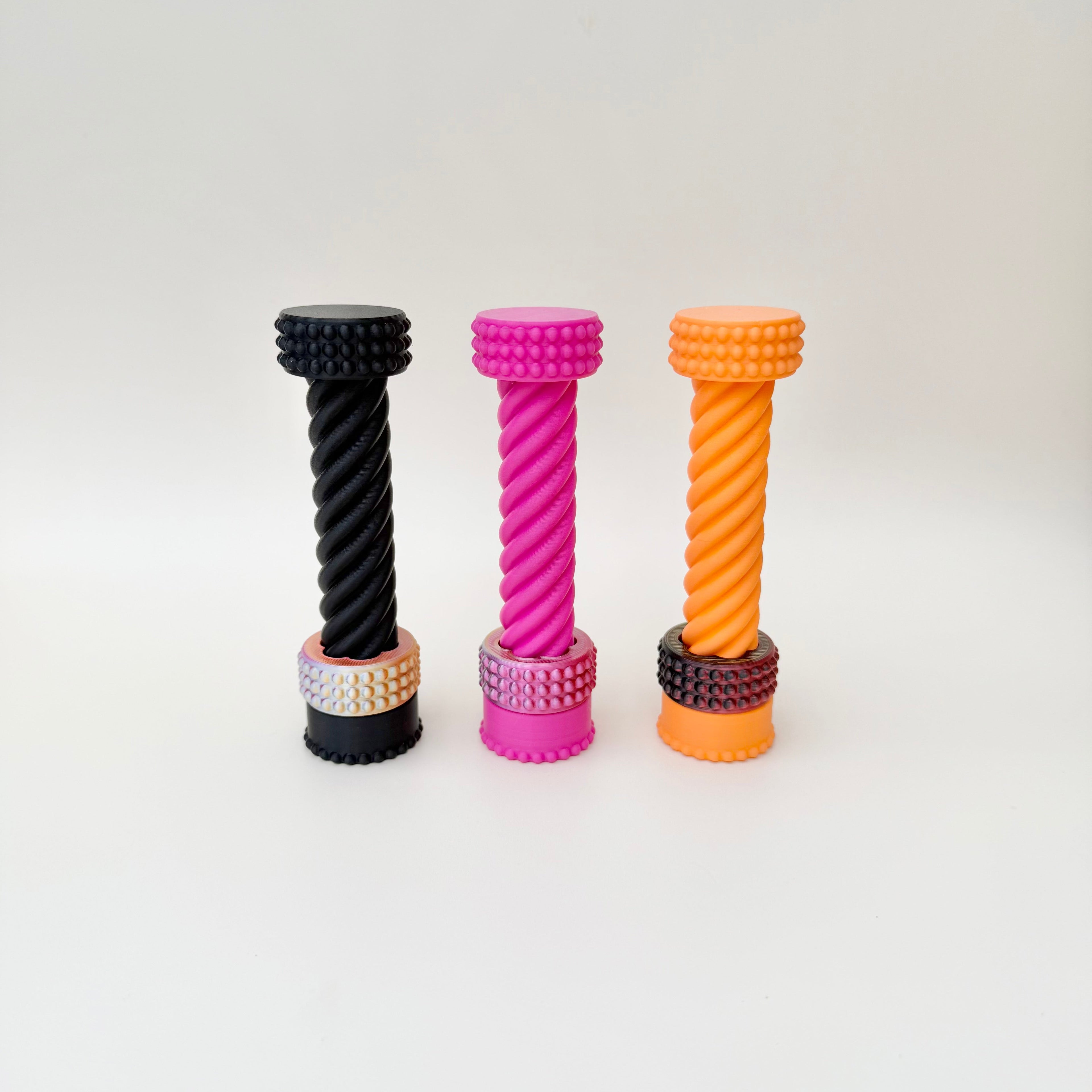 Long spiral sensory fidget with tactile grooves and a colour-shift ring for focus and grounding.

