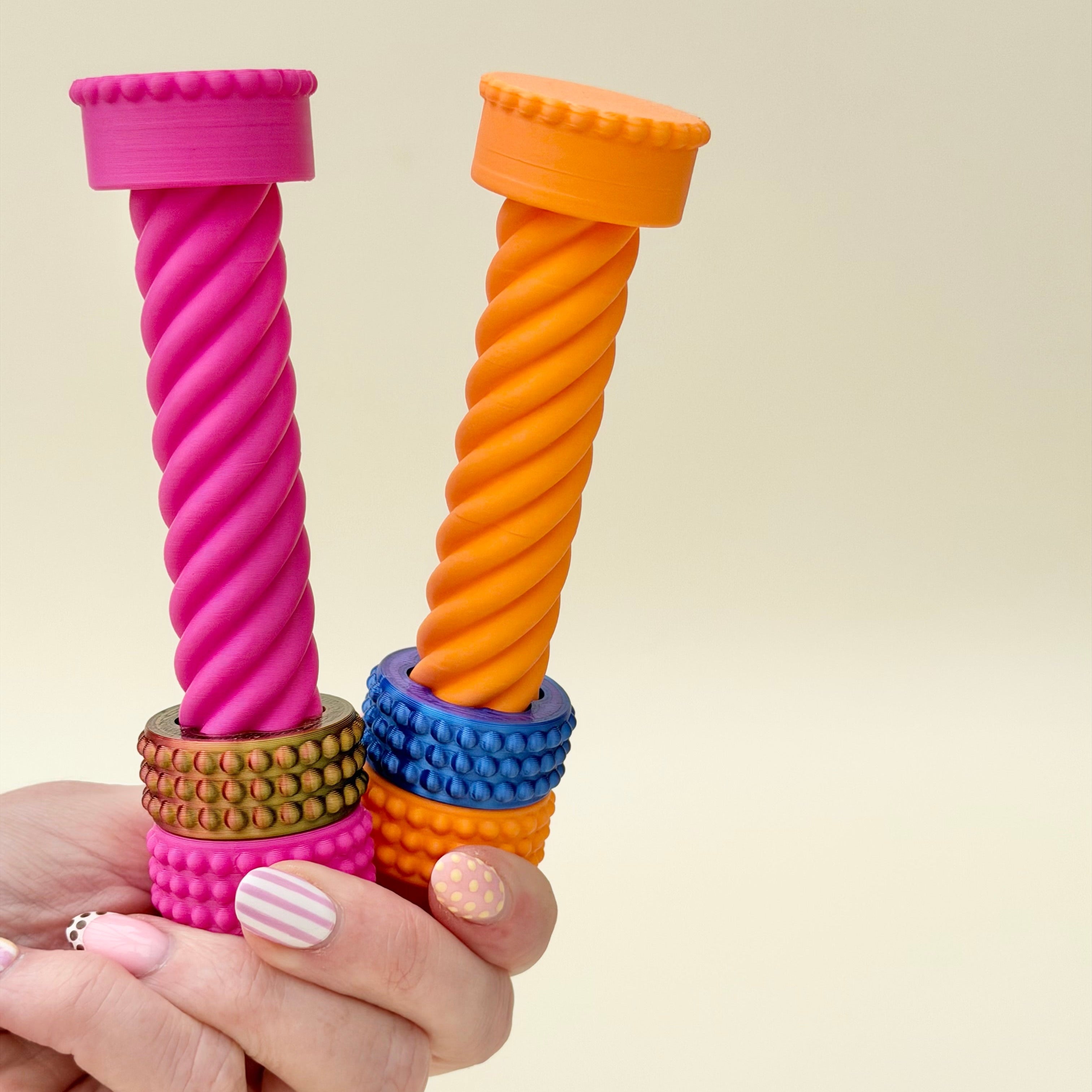 Desk fidget designed for visual stimming with a sliding ring and smooth twisting motion.
