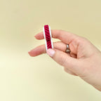 Quiet two-finger sensory fidget with rolling textured wheels for busy hands, grounding and focus support.