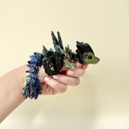 Fantasy-inspired dragon fidget toy featuring a black base and shimmering wings