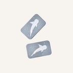 Two matching whale shark magnets designed to slide twist separate and reconnect in the hand.