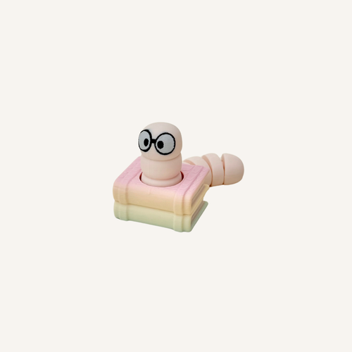 Kawaii bookworm clicker fidget with articulated tail for sensory play, focus hands, and desk comfort.
