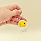 Cute egg-shaped clicker fidget with keyring loop for bags and lanyards, tactile press stim for focus and calming.
