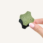 Pocket-sized magnetic fidget with firmer resistance, textured ridges and a satisfying snap-back movement.