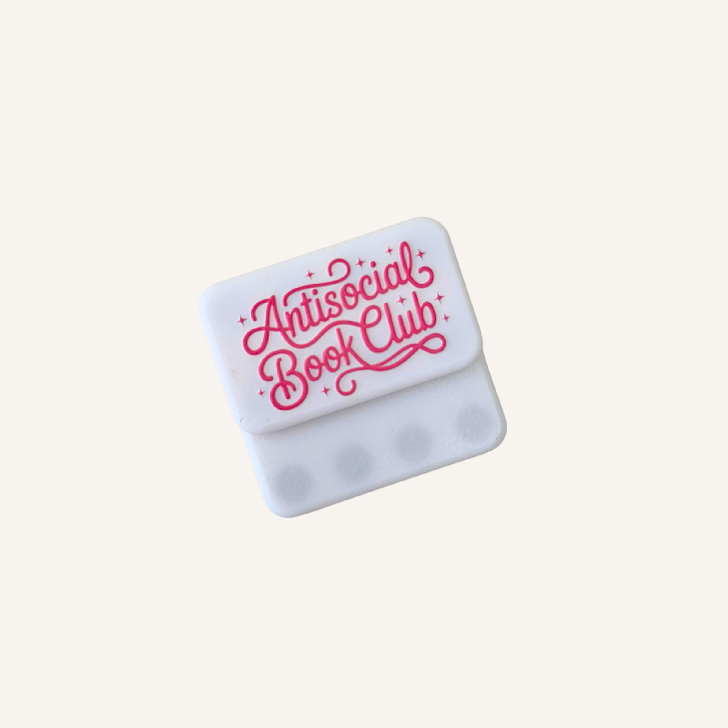 White and pink magnetic sensory fidget pair with a playful book club design for adult readers.
