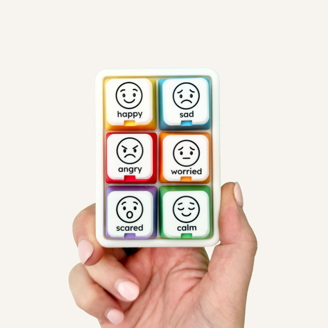COMMZ Click emotions communication tool featuring six colour-coded clickers with interchangeable visual emotion symbols.