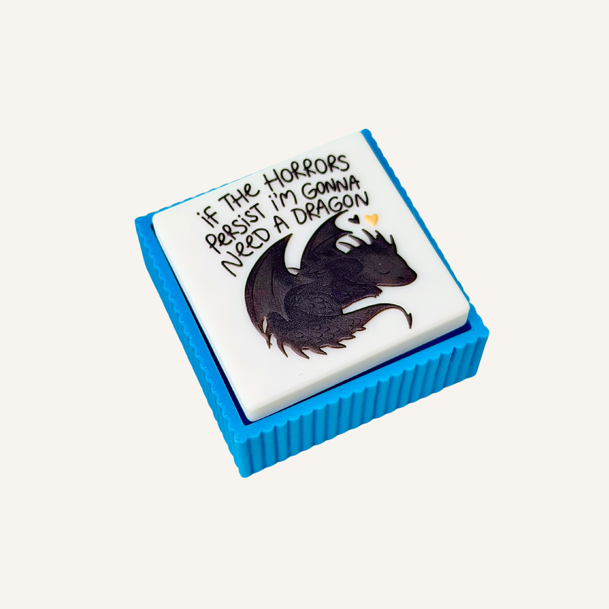 Handheld sensory clicker designed for fantasy readers and dragon lovers with a choice of quiet or noisy click.