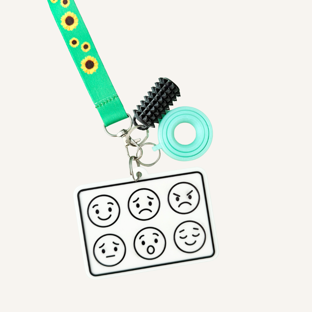 Portable Feelings Communication Board with attachment hole and metal ring for carrying or attaching to a lanyard.