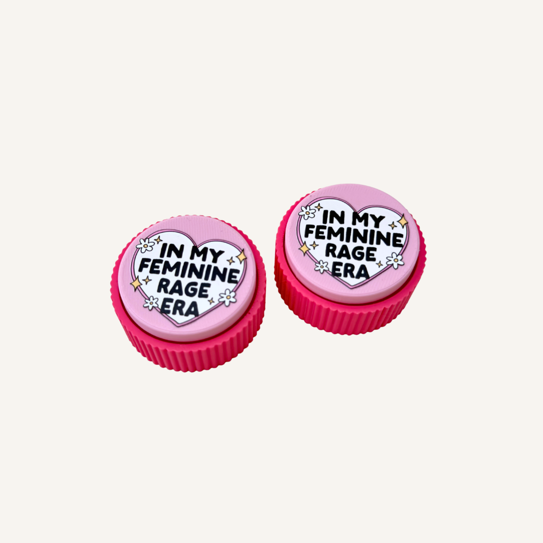 Palm-sized Feminine Rage Clicker designed for repetitive clicking and tactile fidgeting at home, work or your desk.