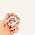 Compact adult sensory fidget with press down clicker and tactile ridged outer edge.