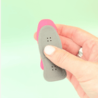 Two textured magnetic fidgets sliding up and down against each other with audible magnetic snapping.