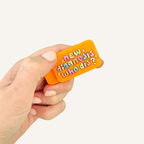 Pair of orange magnetic sensory fidgets with colourful New Diagnosis Who Dis design.