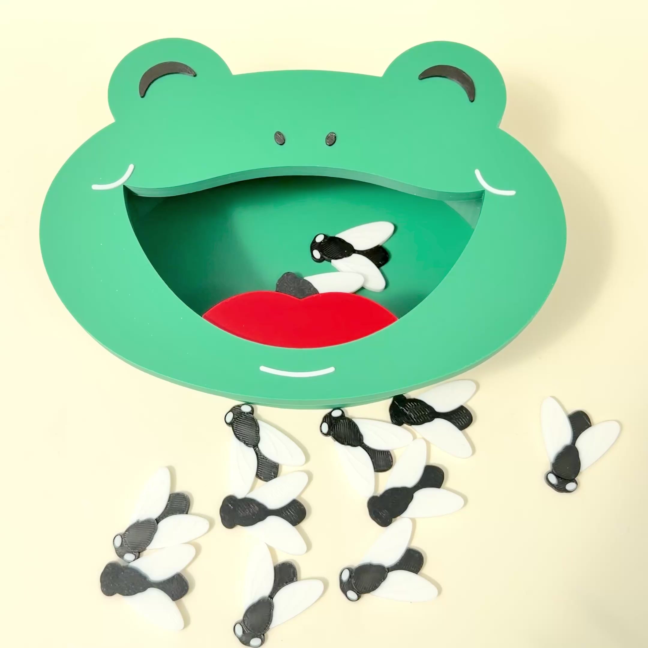 Hands-on frog activity with tweezers and flies for grip practice, coordination and sensory learning.