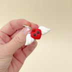A cute Valentine’s keyring with a red heart and moving wings for sensory play.