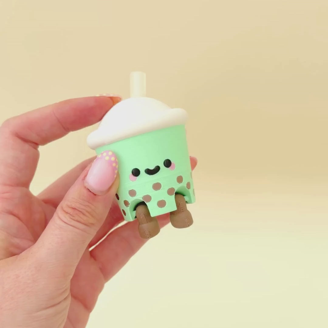 Jellycat-style boba tea clicker fidget with smooth finish and playful character for desk or bag moments.
