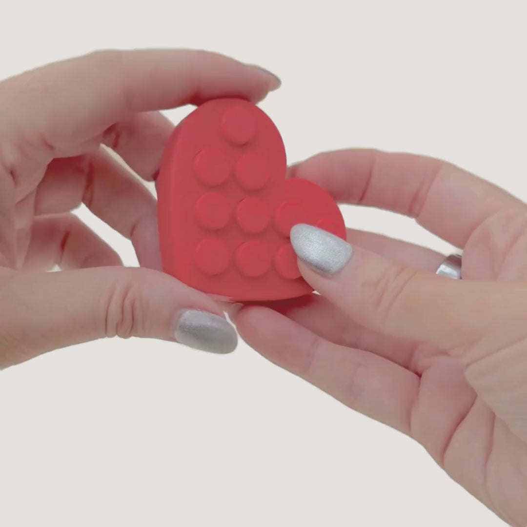 Small handheld pop back fidget offering calming tactile feedback for everyday regulation.
